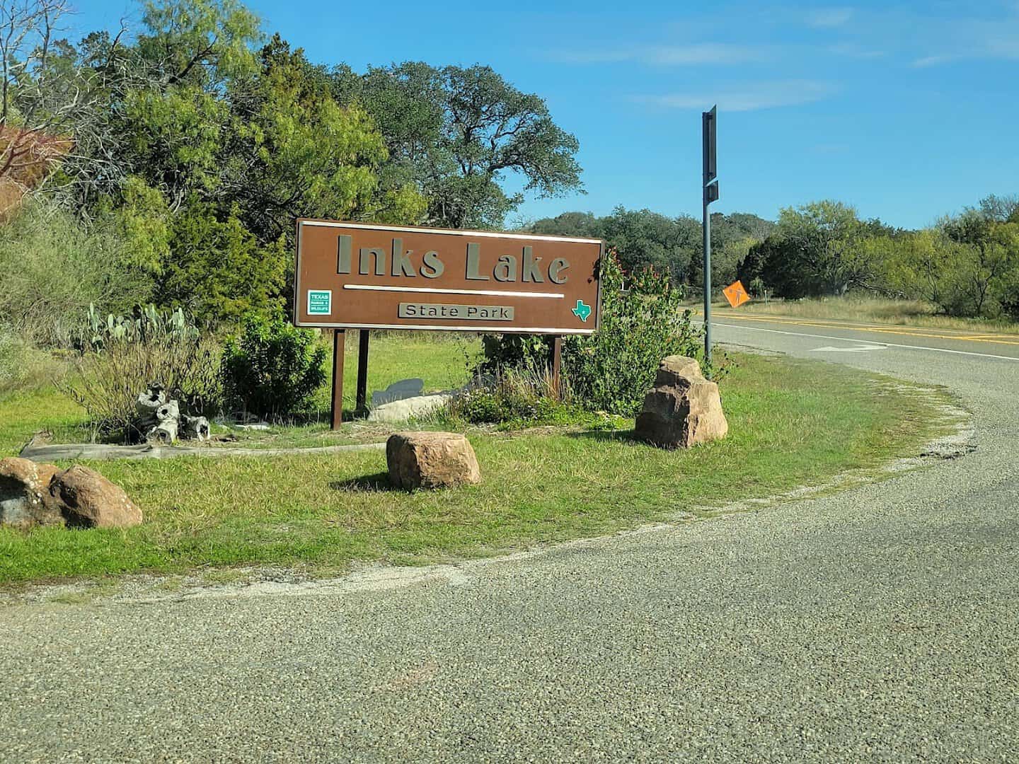 Inks Lake State Park entrance sign along the park road near Burnet, Texas
