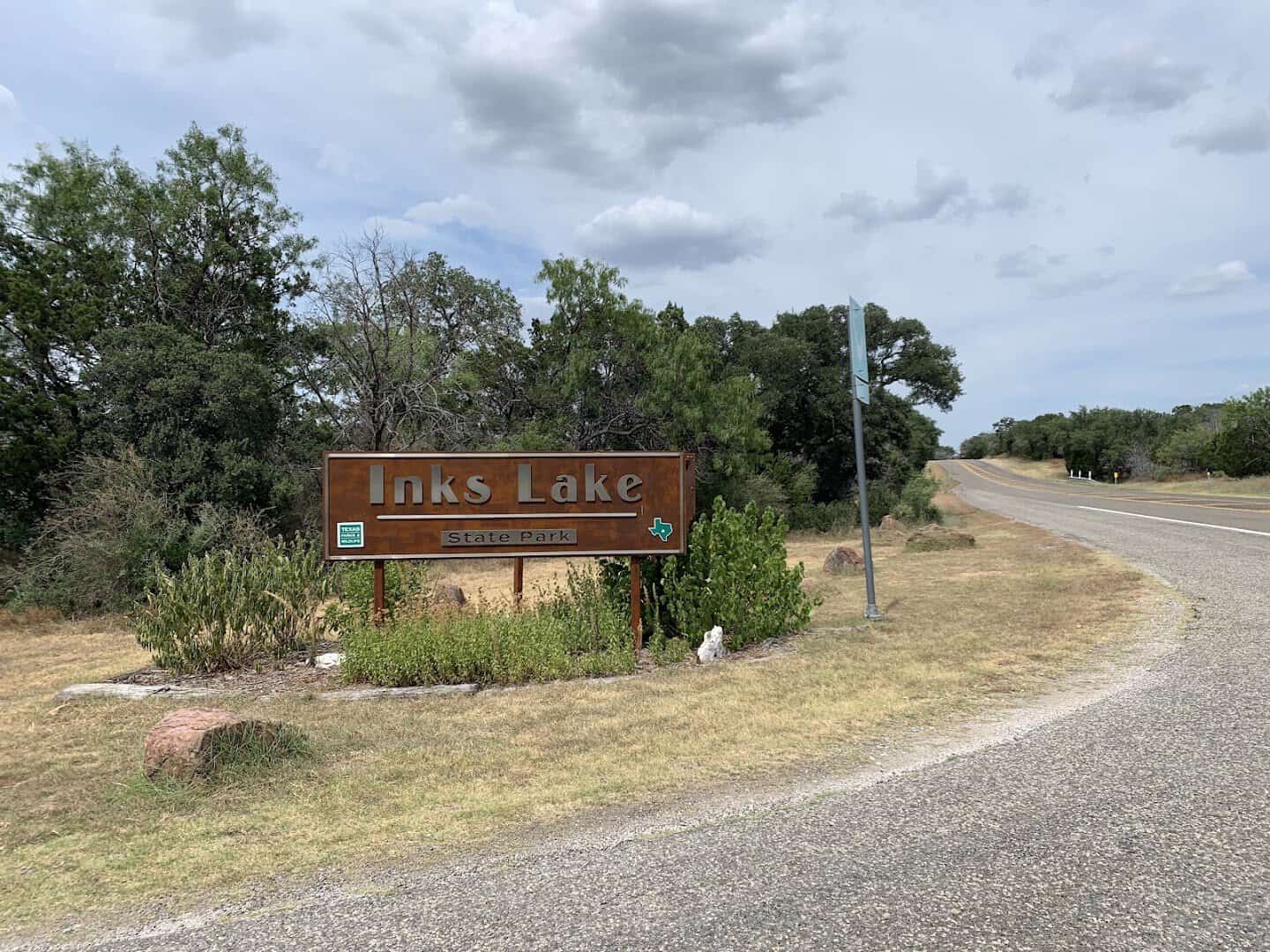 Inks Lake State Park entrance sign and park road near Burnet, Texas