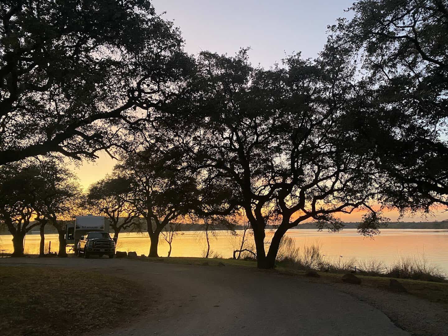 Lakeside picnic spot under oak trees at Inks Lake State Park
