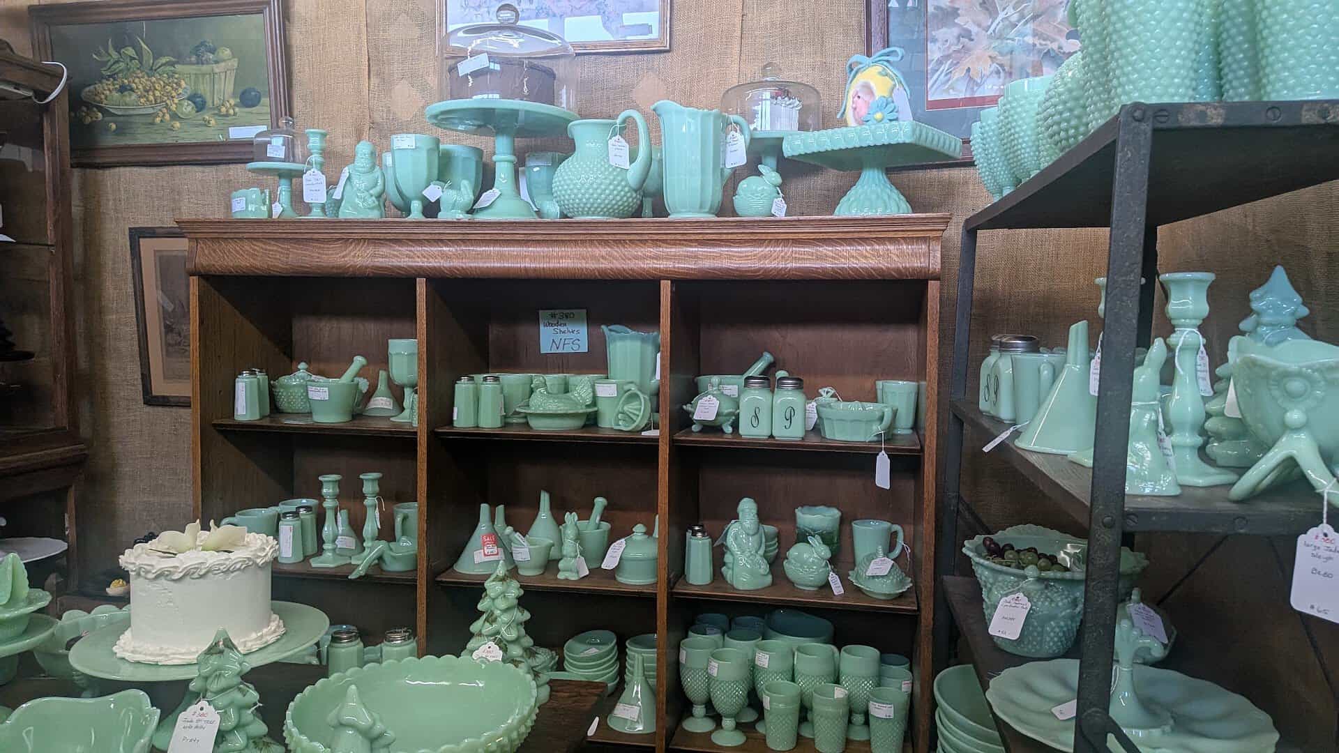 Shelves of jadeite green glassware for sale at a Fort Worth antique mall