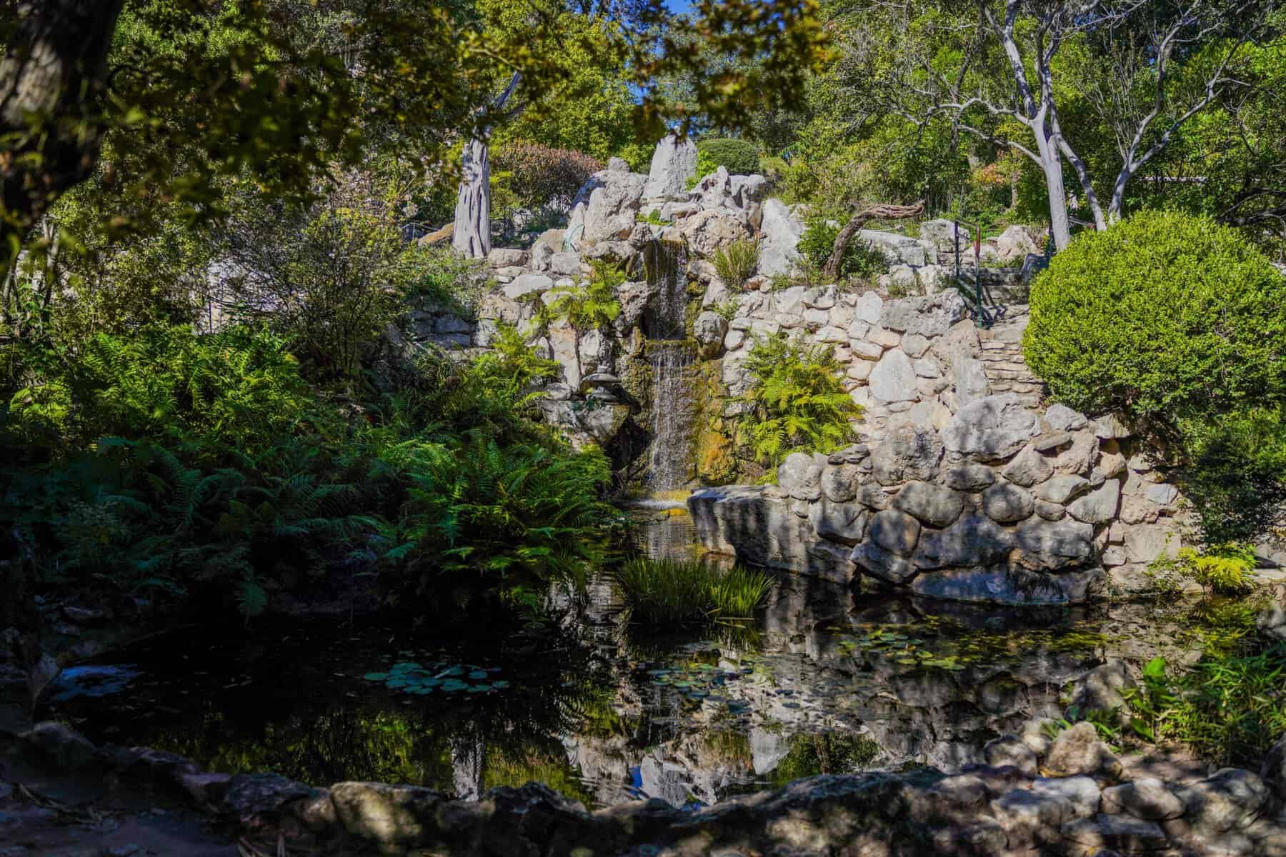 A rock waterfall and stream in the Japanese garden at Zilker Botanical Garden in Austin, Texas