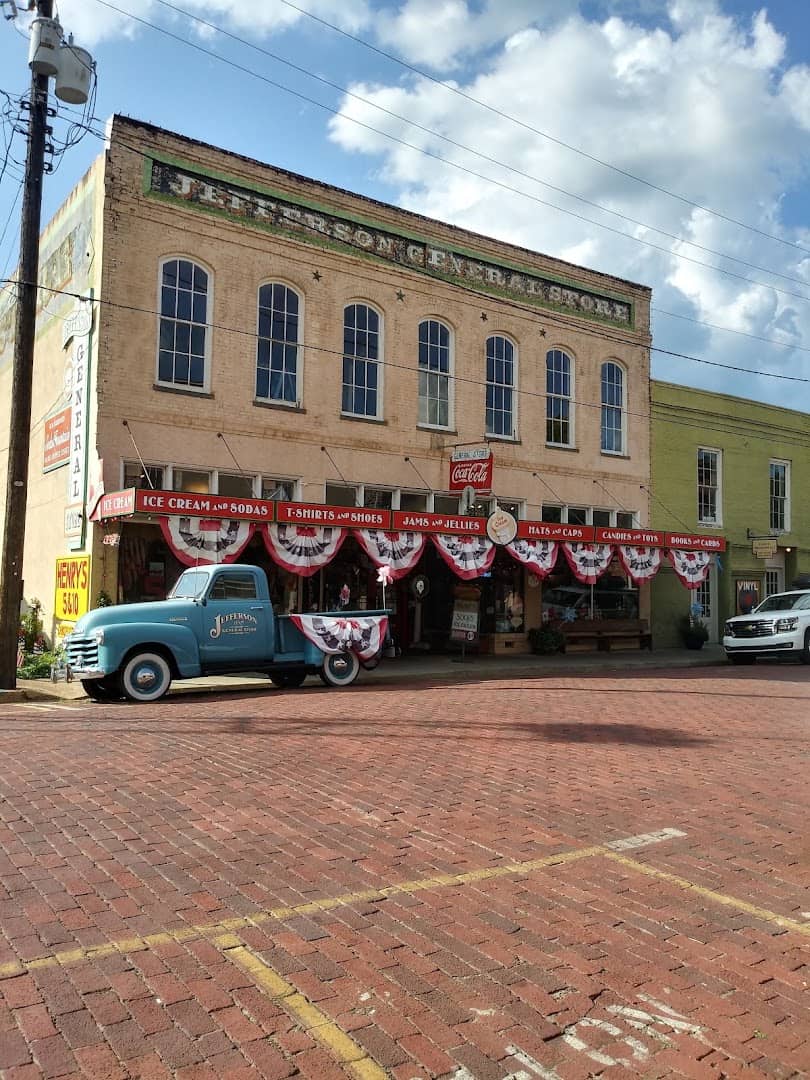Historic brick storefronts and a vintage truck in Jefferson, Texas