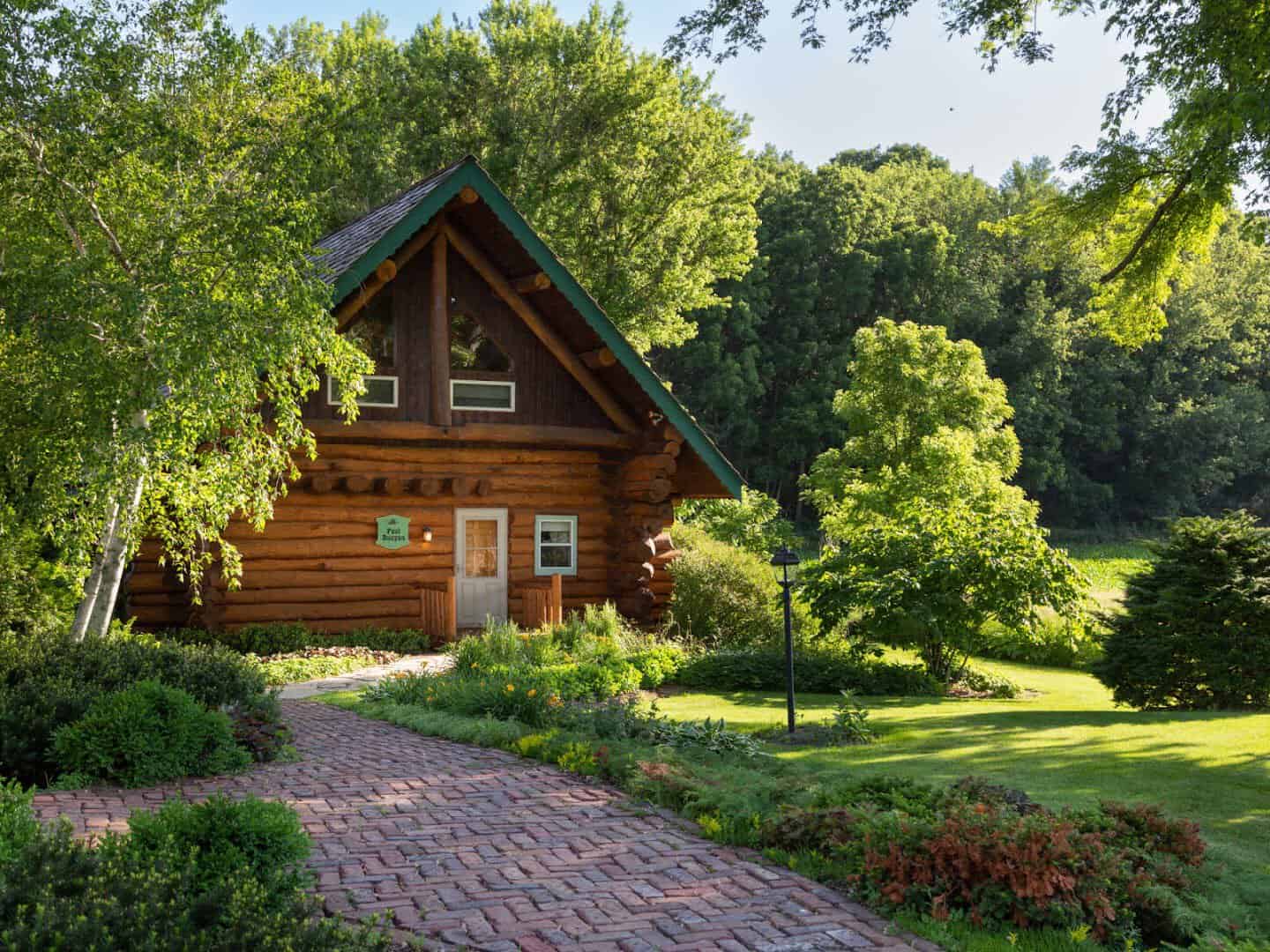 Log cabin on a green lawn at Justin Trails Resort near Sparta, Wisconsin