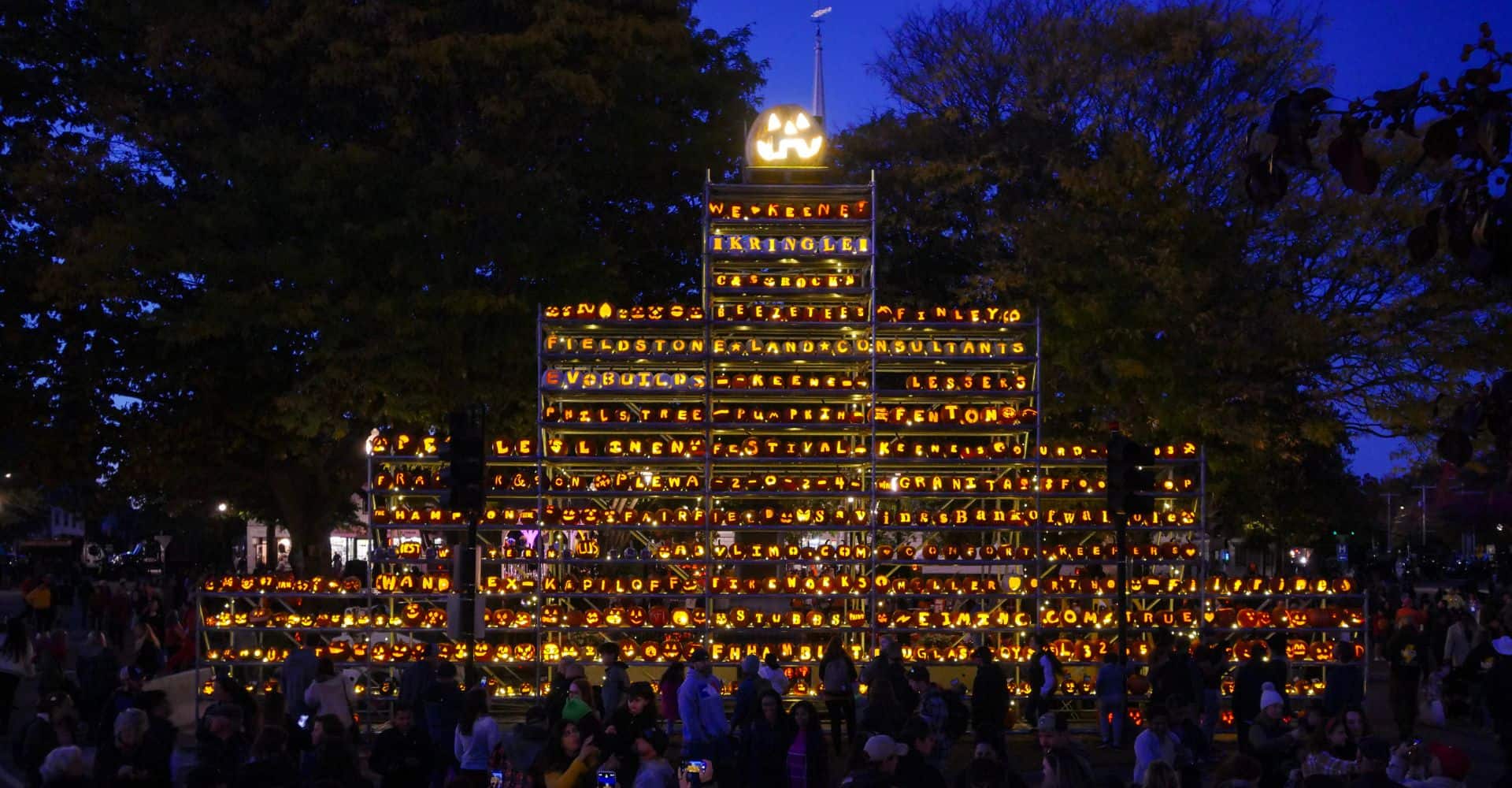 Illuminated tower of lit jack-o-lanterns at the Keene Pumpkin Festival in Keene, New Hampshire