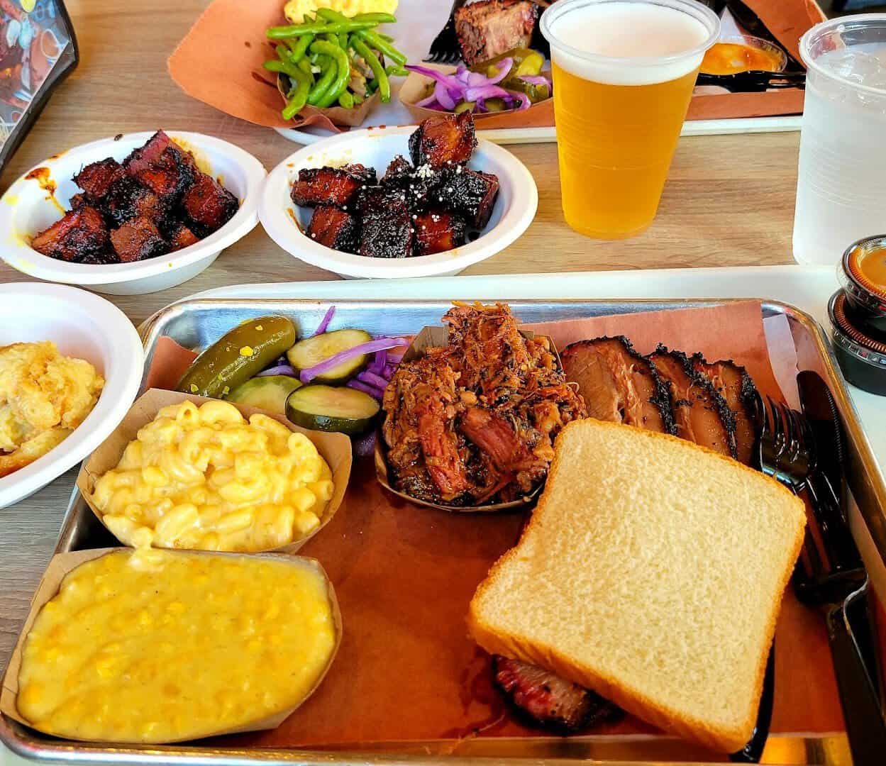 A family-style barbecue feast with brisket, pork belly, sides and beer at Killen's Barbecue in Pearland, Texas