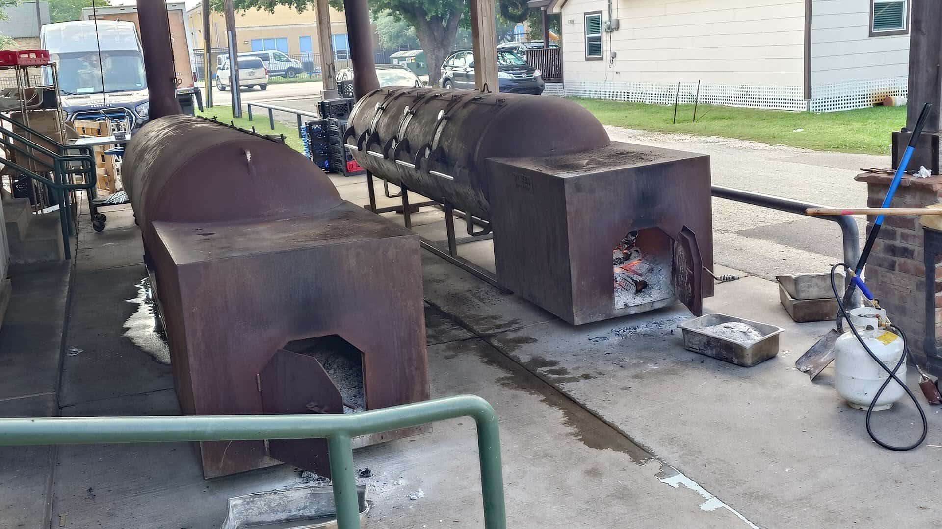 Offset smokers with a live fire burning at Killen's Barbecue in Pearland, Texas