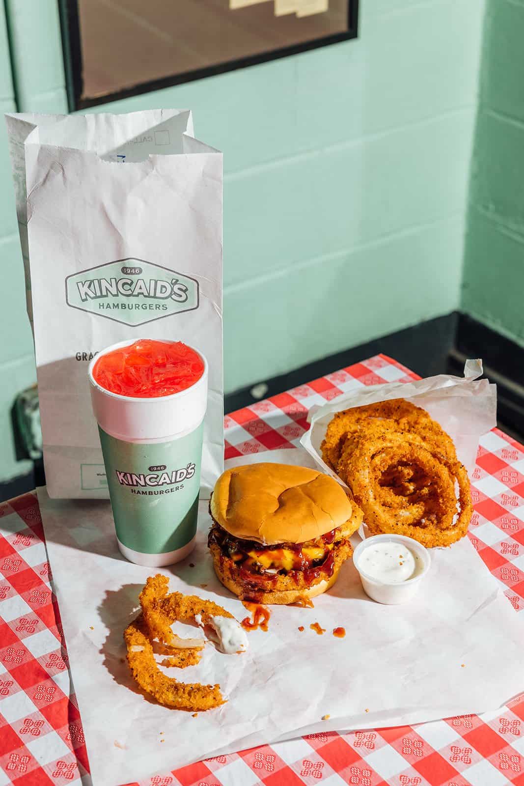 Chili cheeseburger with onion rings and a drink at Kincaid's Hamburgers in Fort Worth