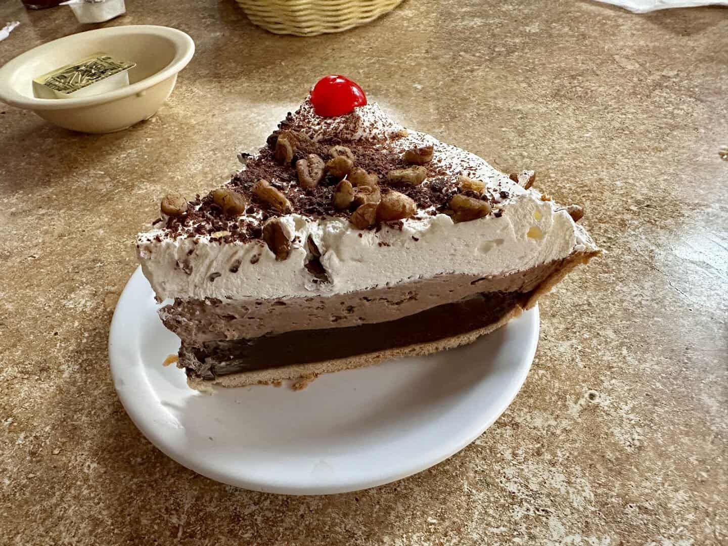 Slice of cream pie topped with a cherry at Koffee Kup Family Restaurant in Hico