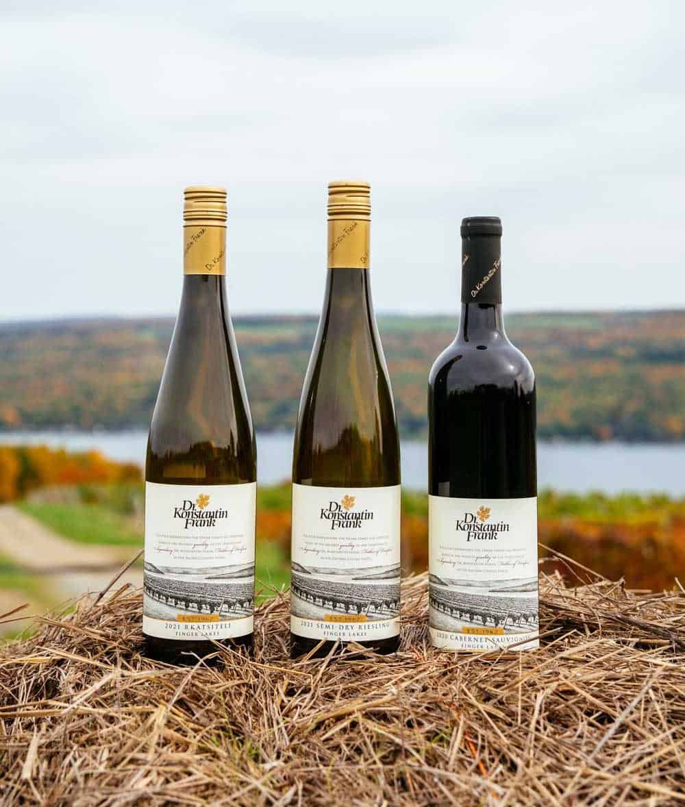 Dr. Konstantin Frank Winery wine bottles with fall foliage over Keuka Lake, New York
