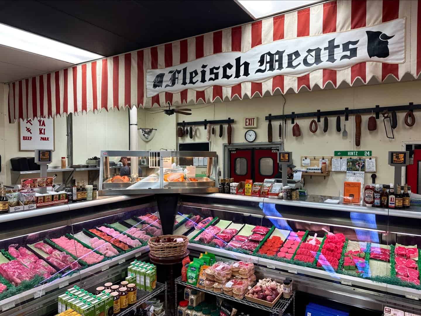 Fresh meats in the butcher case under the Fleisch Meats sign at Kuby's in Dallas