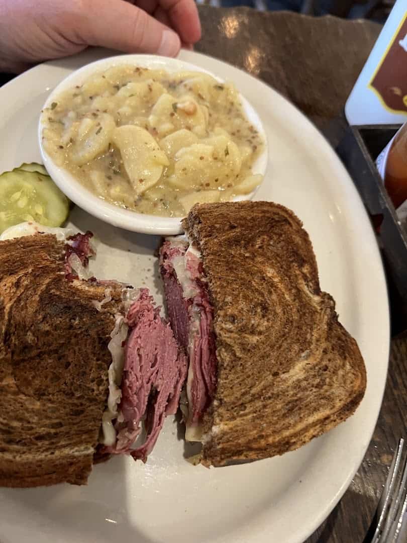 Reuben sandwich on rye with house-made corned beef and German potato salad at Kuby's in Dallas