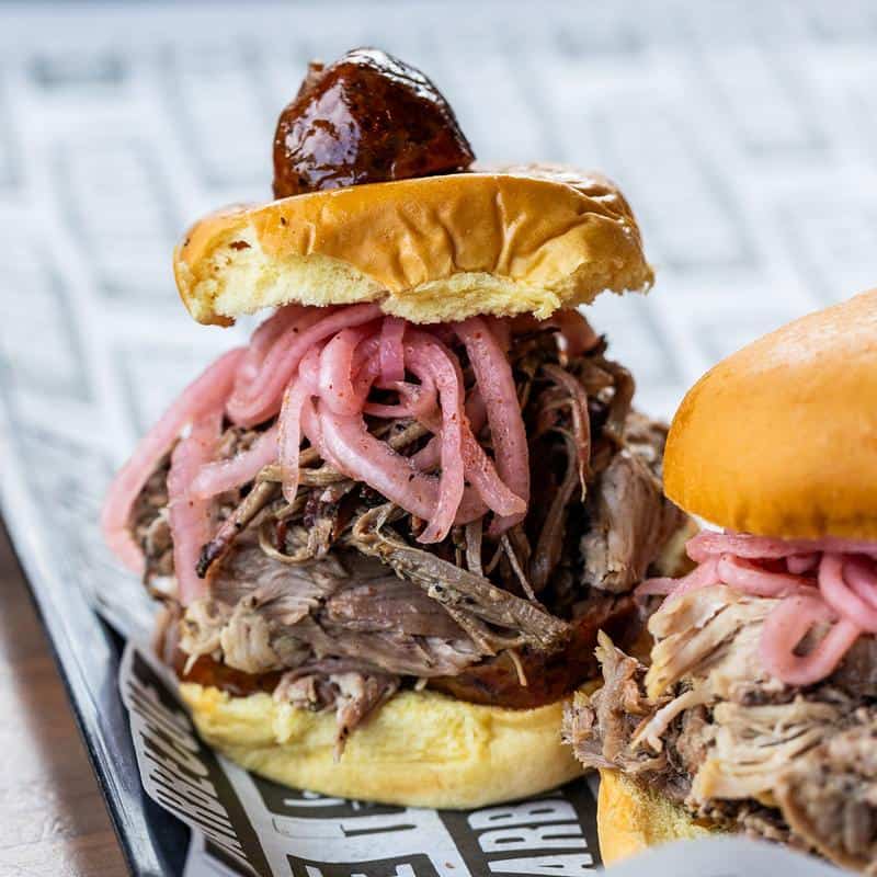 Brisket and pulled pork sandwiches with pickled onions at la Barbecue in Austin, Texas