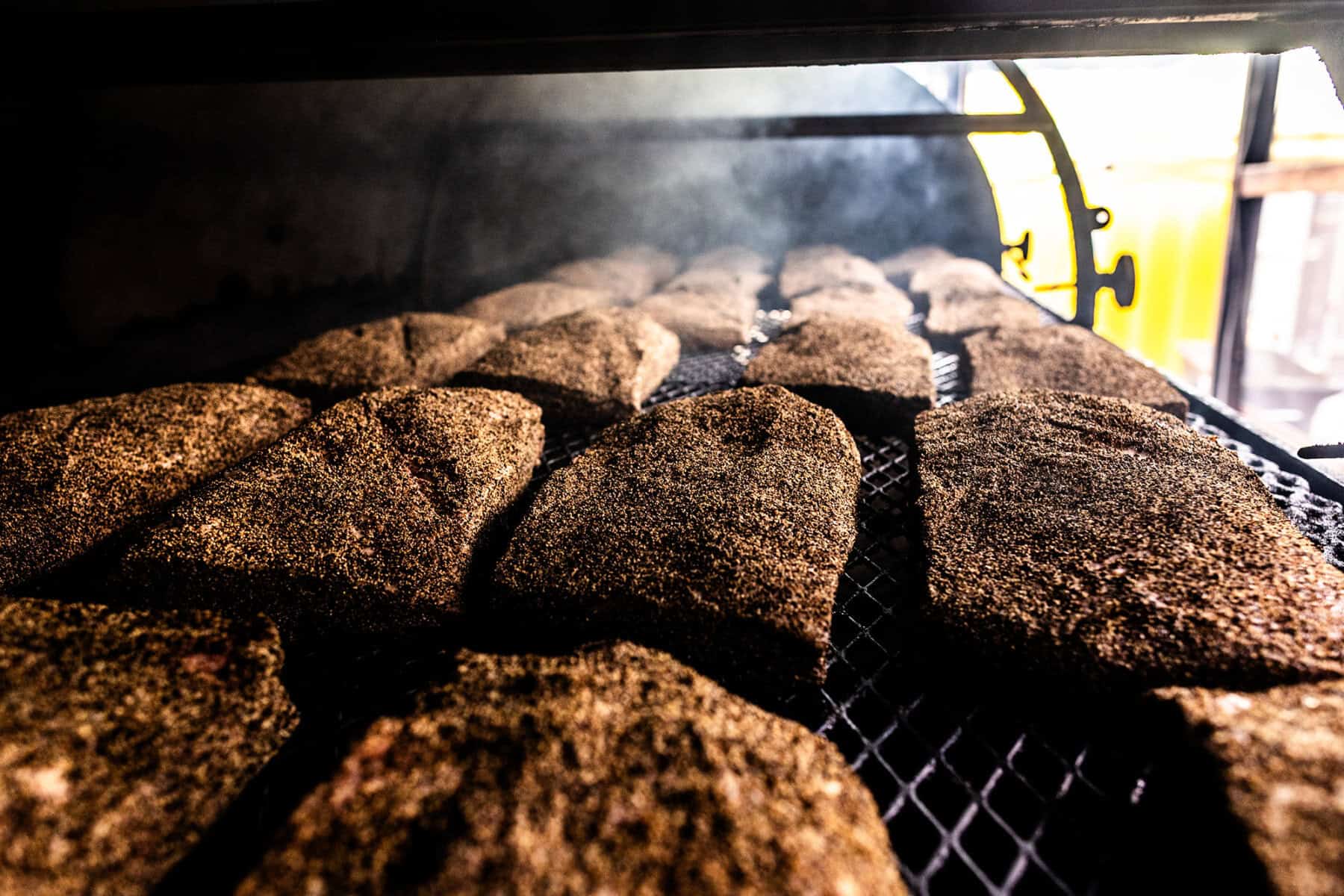 Briskets smoking in the custom pit at la Barbecue in Austin, Texas