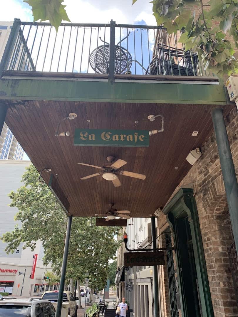 La Carafe balcony sign and ceiling fan on the historic building in Houston