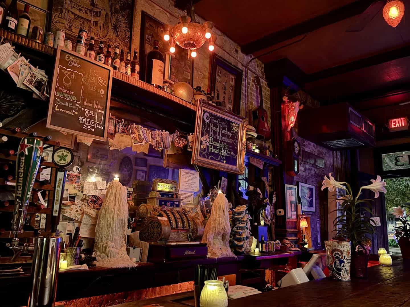Candlelit bar room at La Carafe with chalkboard menus in Houston