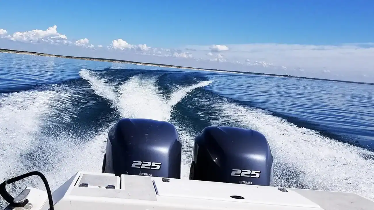 Motorboat cutting a wake across the blue water of Lake Amistad, Texas