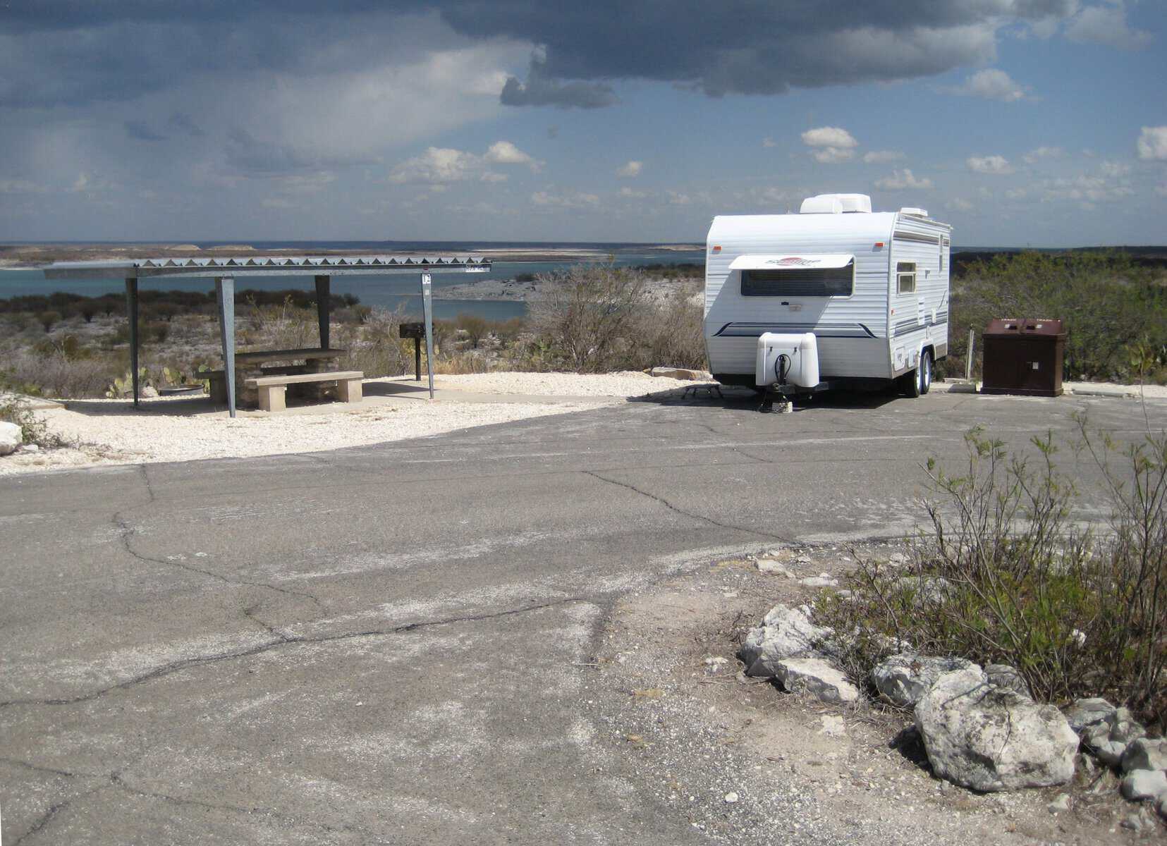 A lakeside campsite with a shade shelter at Amistad National Recreation Area, Texas