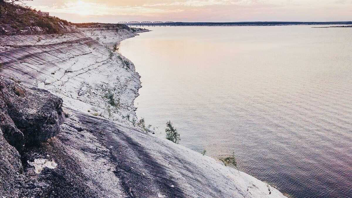 Clear calm water along the limestone shore of Lake Amistad, Texas