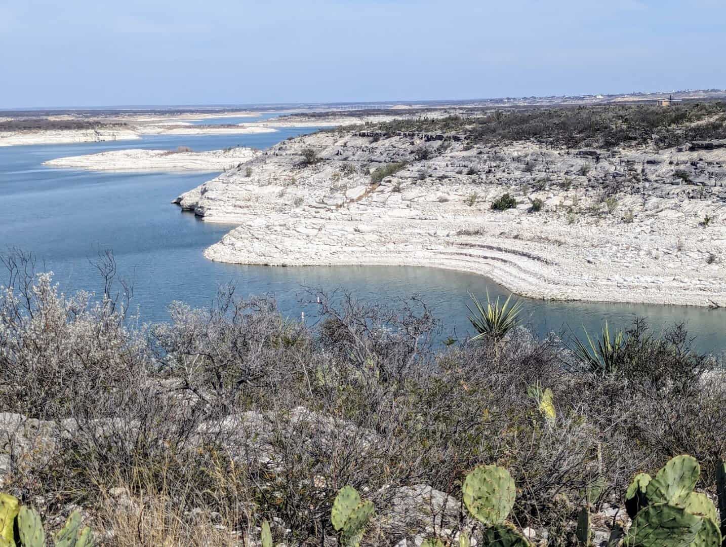 Turquoise cove and desert brush at Lake Amistad, Texas