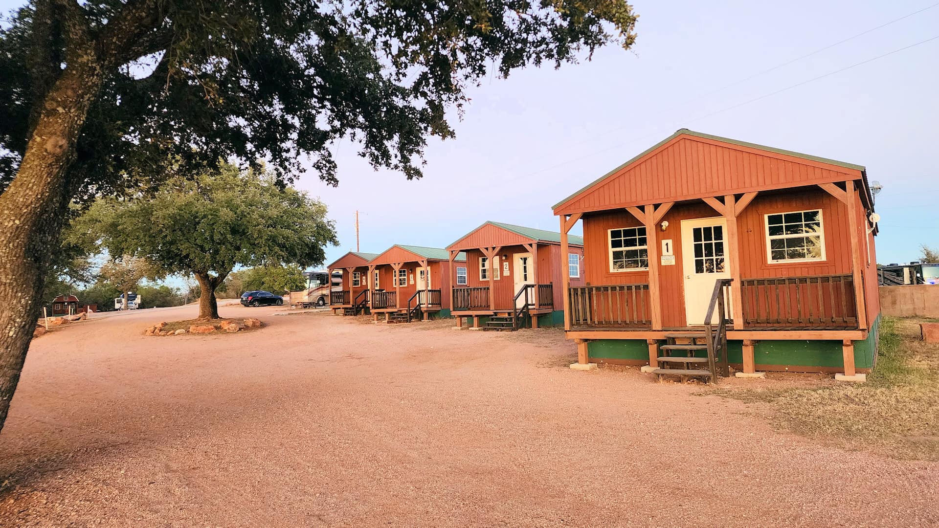 Row of waterfront log cabins at Lake Buchanan RV and Cabin Resort in Burnet, Texas