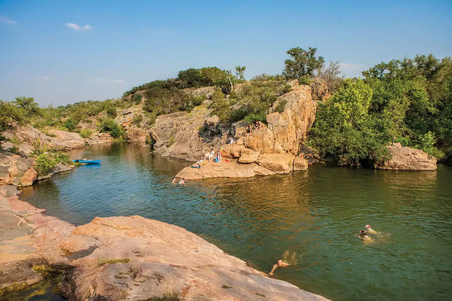 Rocky swimming cove with clear green water near Lake Buchanan in Burnet, Texas