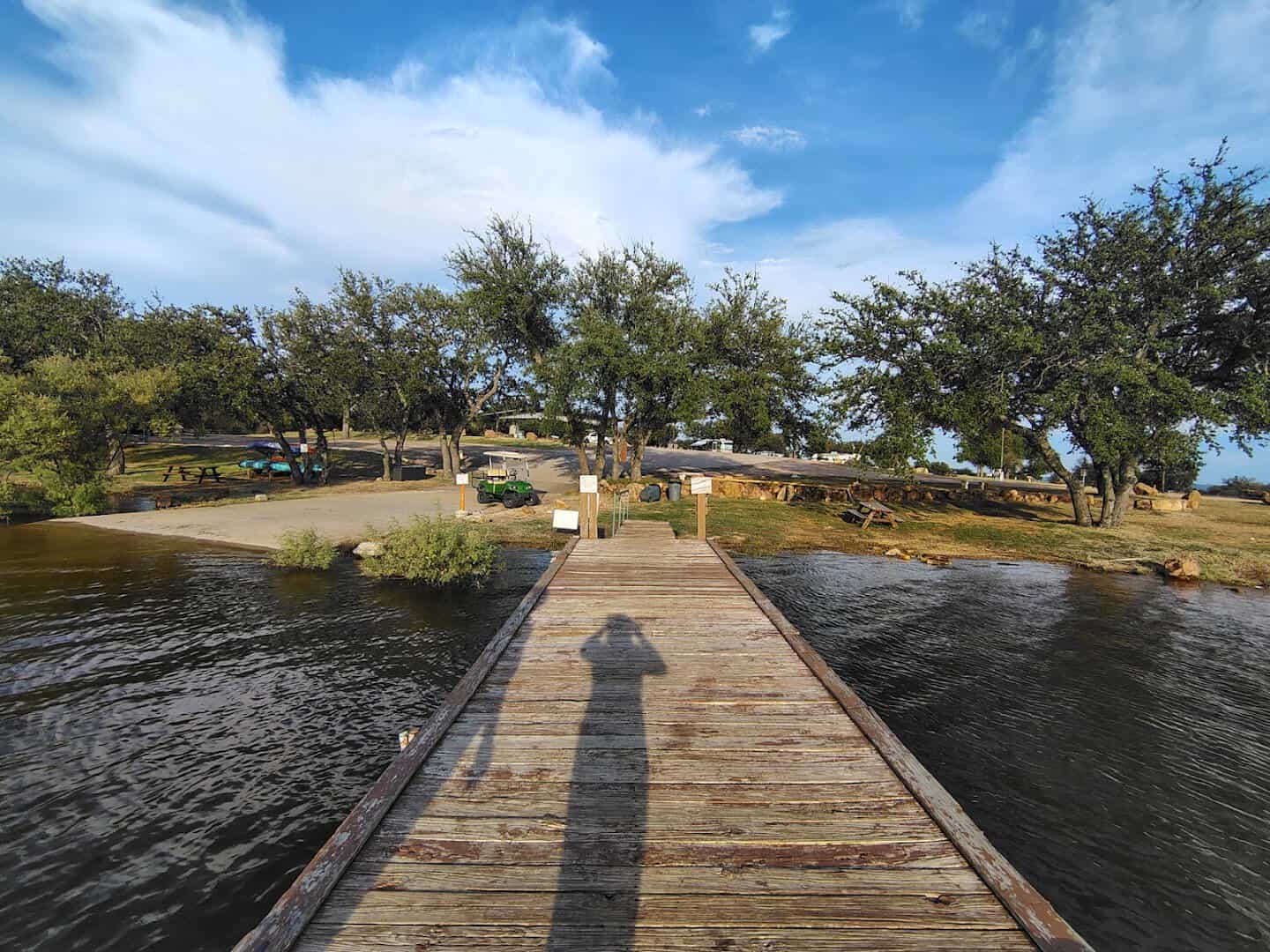 Wooden swimming dock reaching over Lake Buchanan at dusk in Burnet, Texas