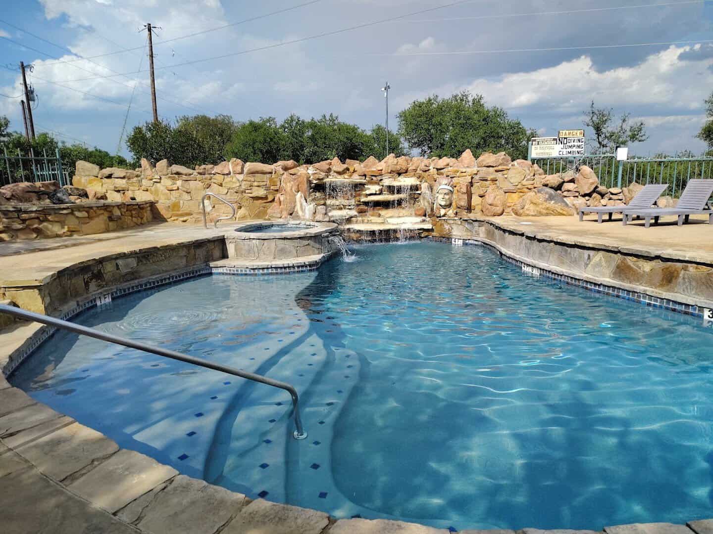 Custom swimming pool with rock waterfall at Lake Buchanan RV and Cabin Resort in Burnet, Texas