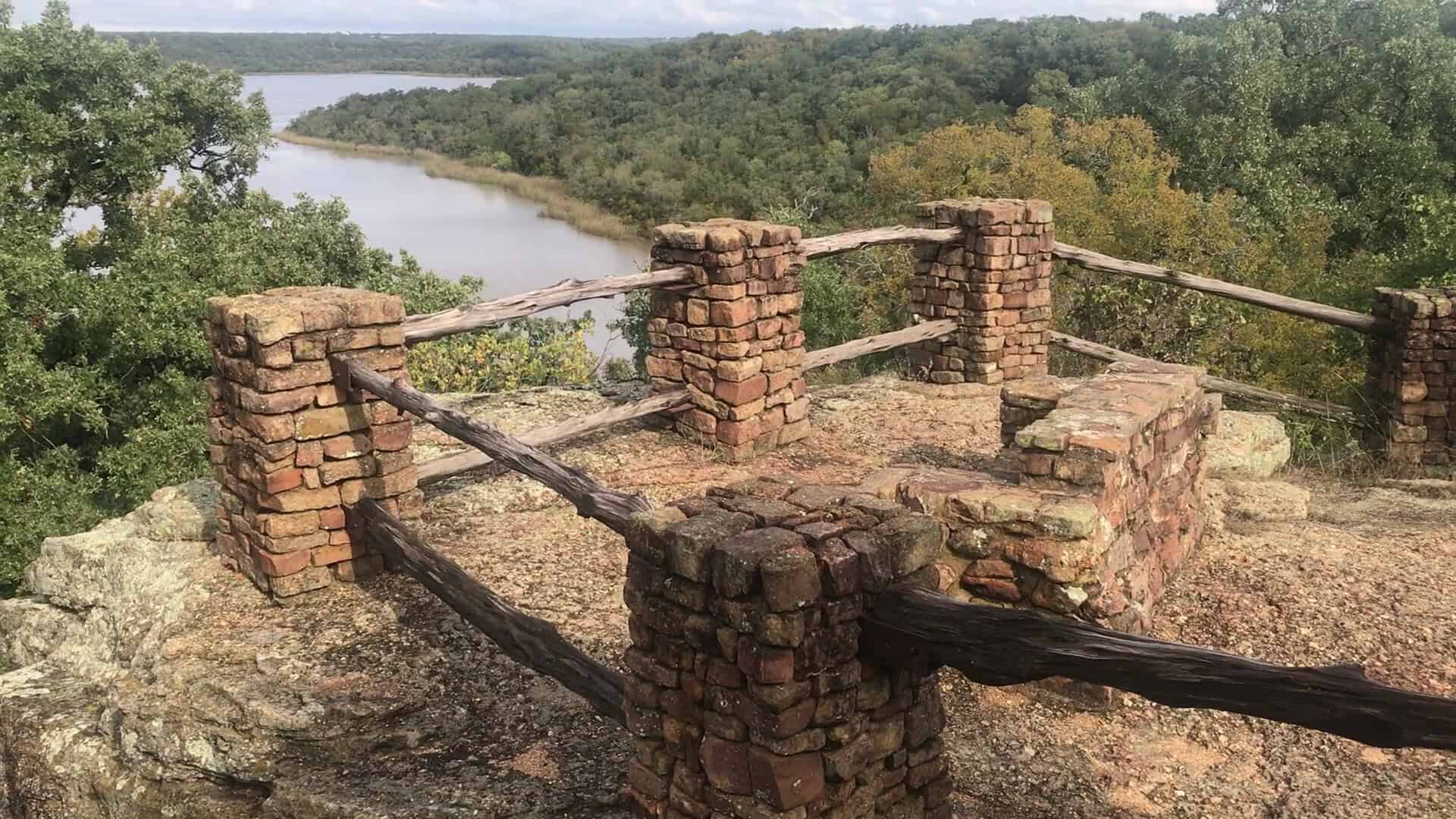 A quiet stone overlook above the calm water at Lake Mineral Wells State Park, Texas