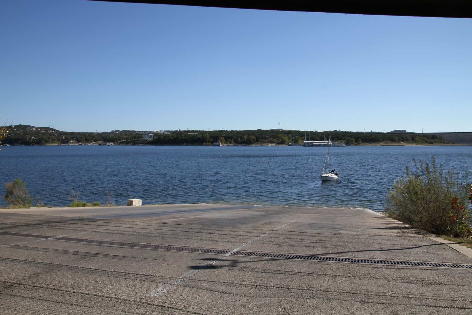 Concrete boat ramp running down into Lake Travis at Mansfield Dam Park