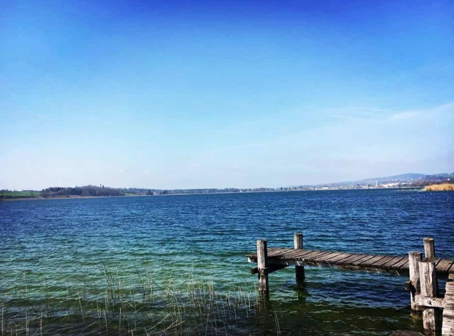 Clear green water and a wooden fishing pier on Lake Travis