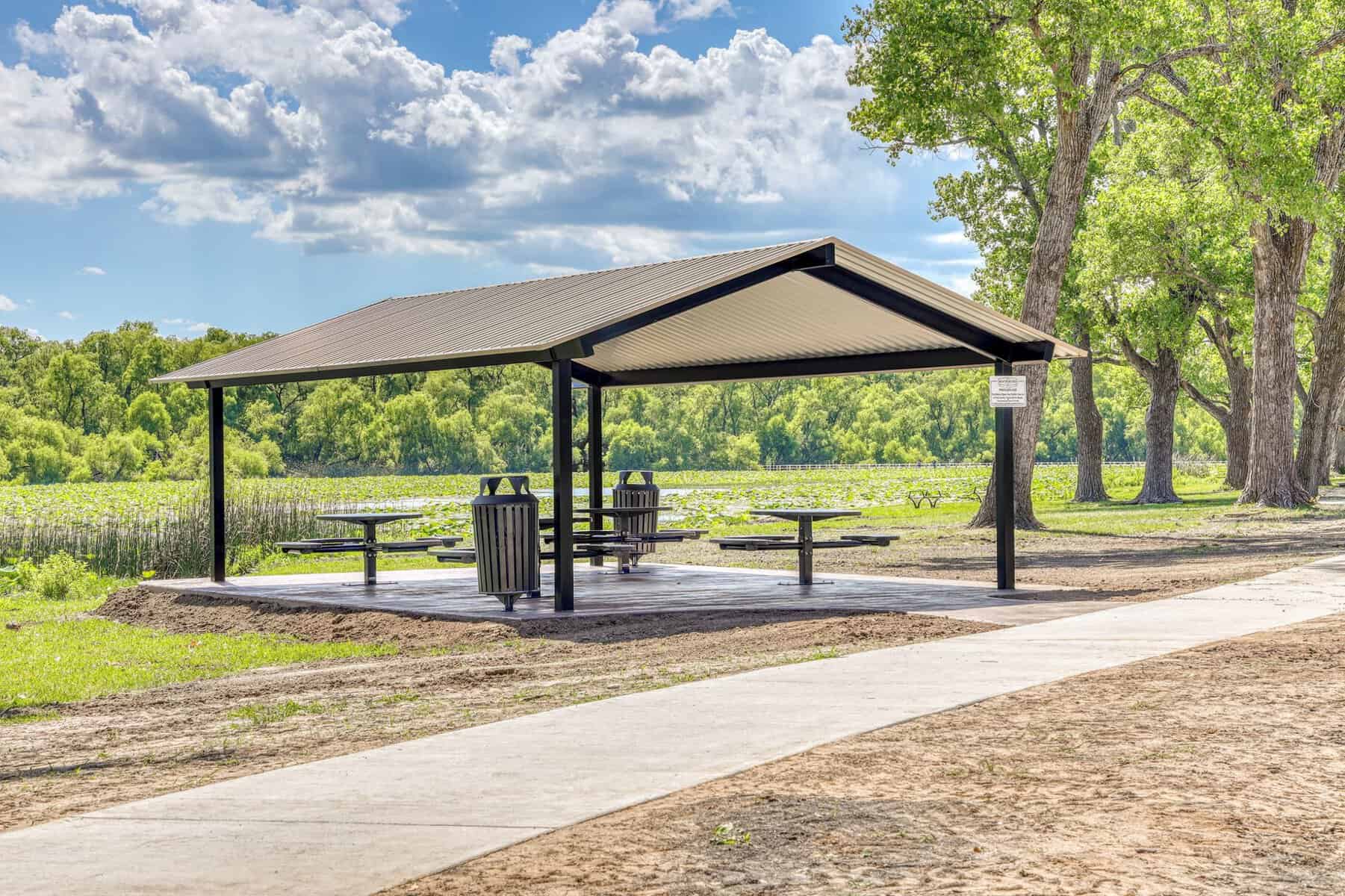 The lakeside pavilion with picnic tables beside the lotus lake at Lake Weatherford, Weatherford Texas