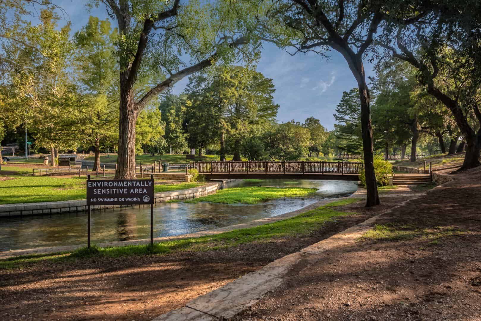 Footbridge crossing the clear spring run at Landa Park in New Braunfels, Texas