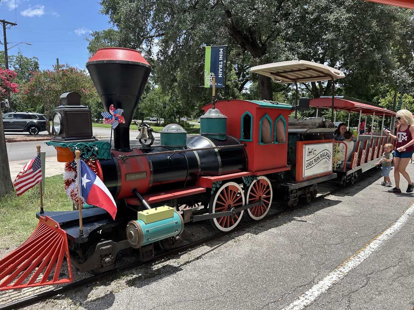 The Landa Park Railroad miniature train engine parked on its track in New Braunfels, Texas