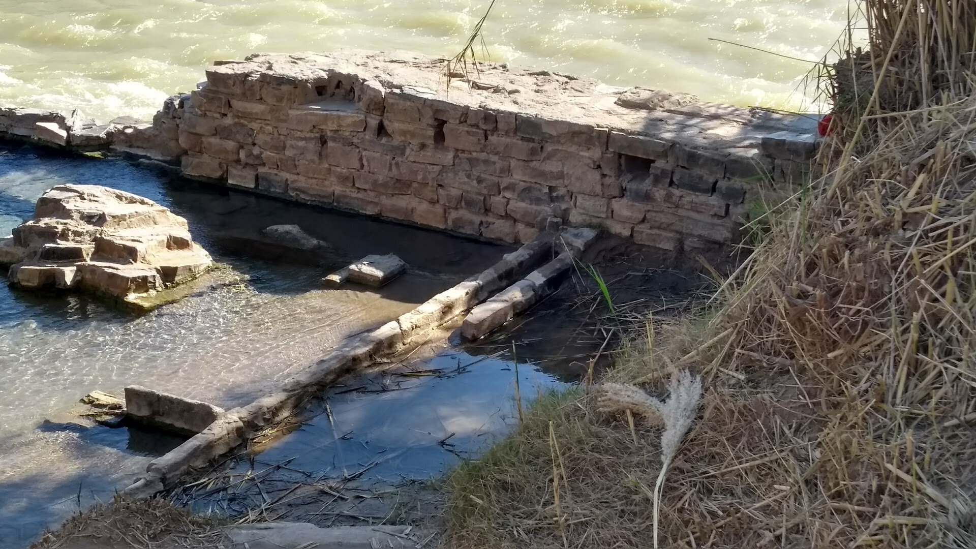 Stone foundation of Langford's old bathhouse at the edge of the Rio Grande