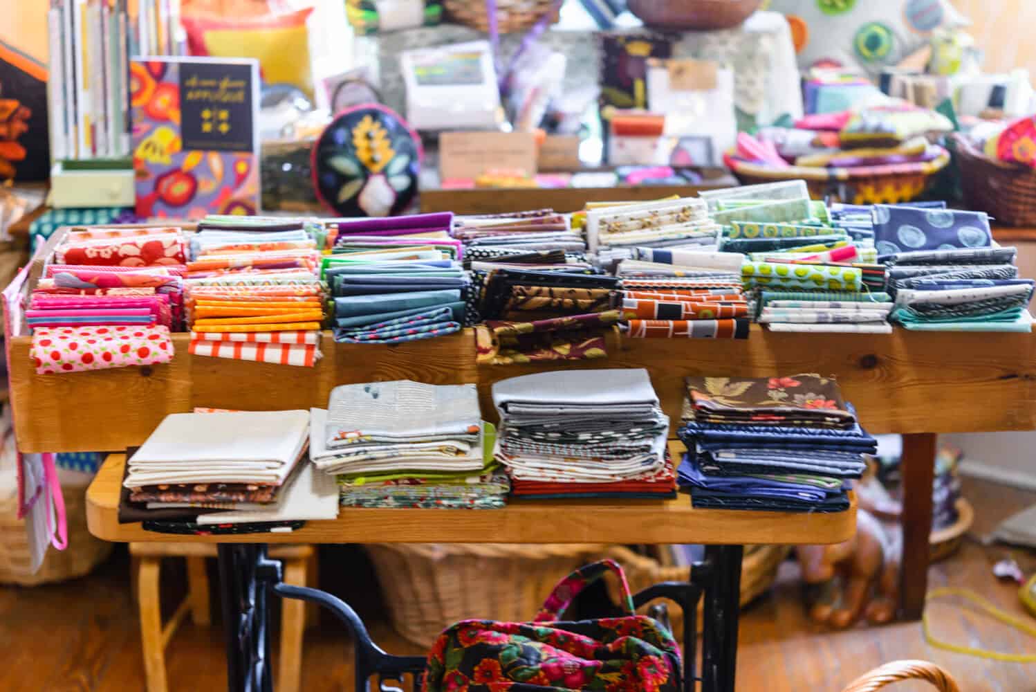 Table of fat quarters and quilting books at Las Colchas in San Antonio