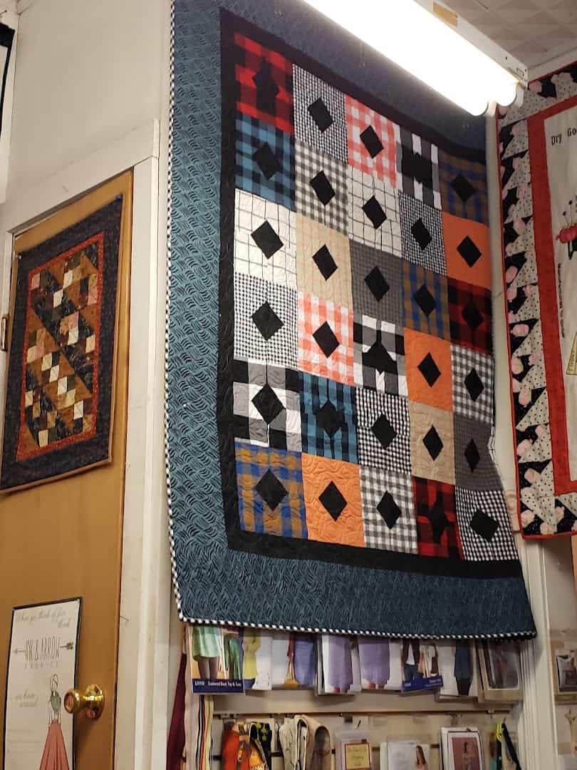 Wall of small quilt block samples at Las Colchas in San Antonio