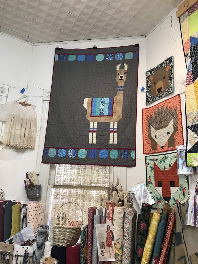 Handmade quilts hanging on the wall at Las Colchas in San Antonio
