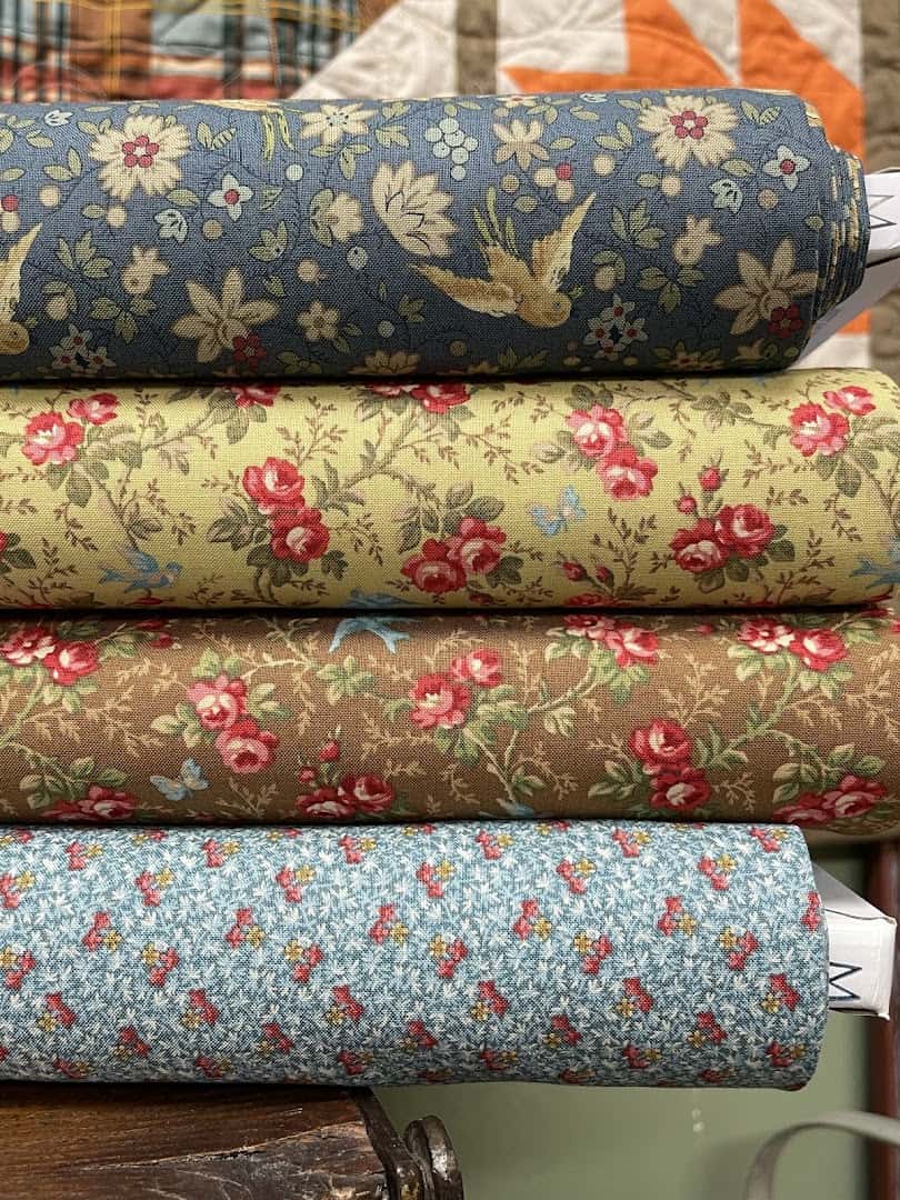 Stacked bolts of floral quilting cotton at Las Colchas in San Antonio