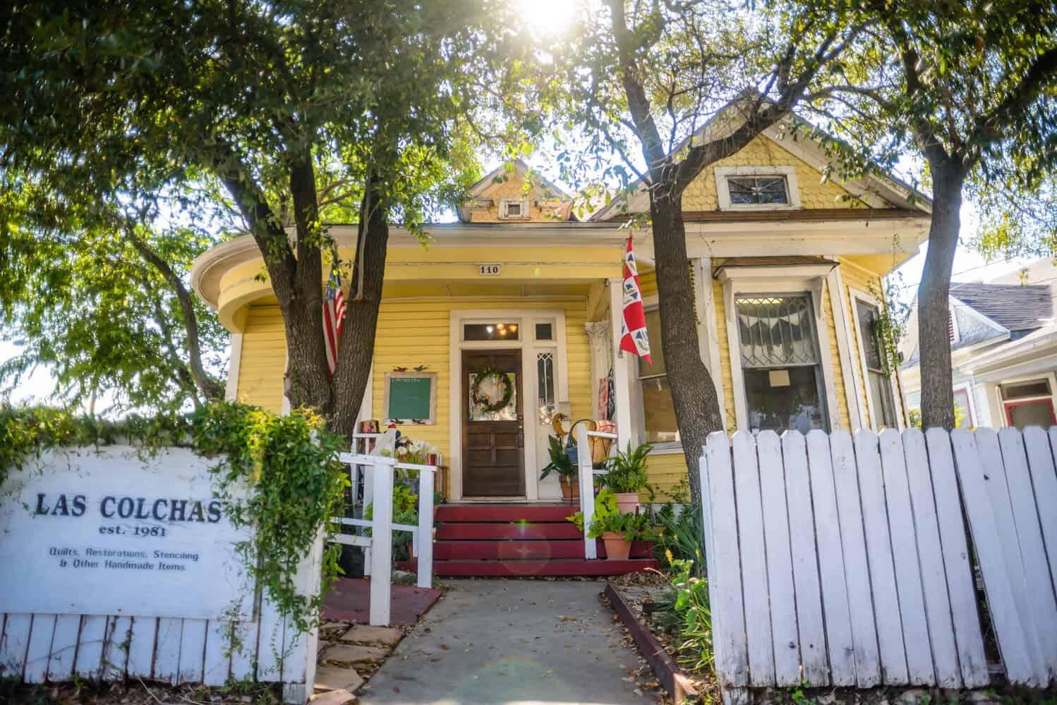 Las Colchas quilt shop storefront, a yellow cottage in San Antonio