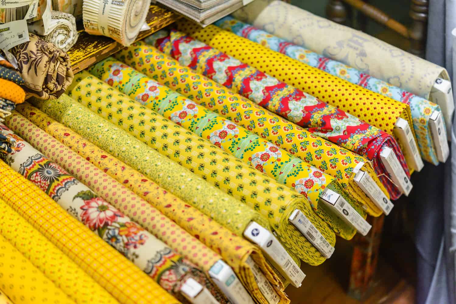 Rolls of yellow and red quilting fabric at Las Colchas in San Antonio