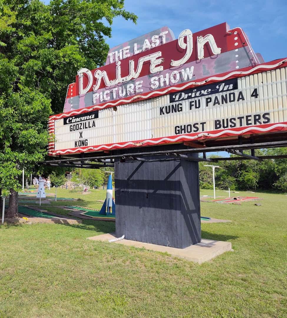 The Last Drive-In Picture Show neon marquee lit up with movie titles in Gatesville, Texas