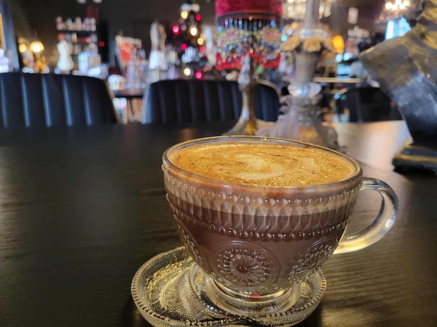 Latte in an ornate glass cup at Triple Six Social in San Marcos