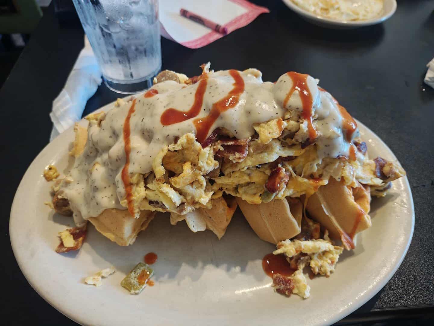 Loaded waffle with eggs, bacon and cream gravy at Jonathon's Diner in Dallas