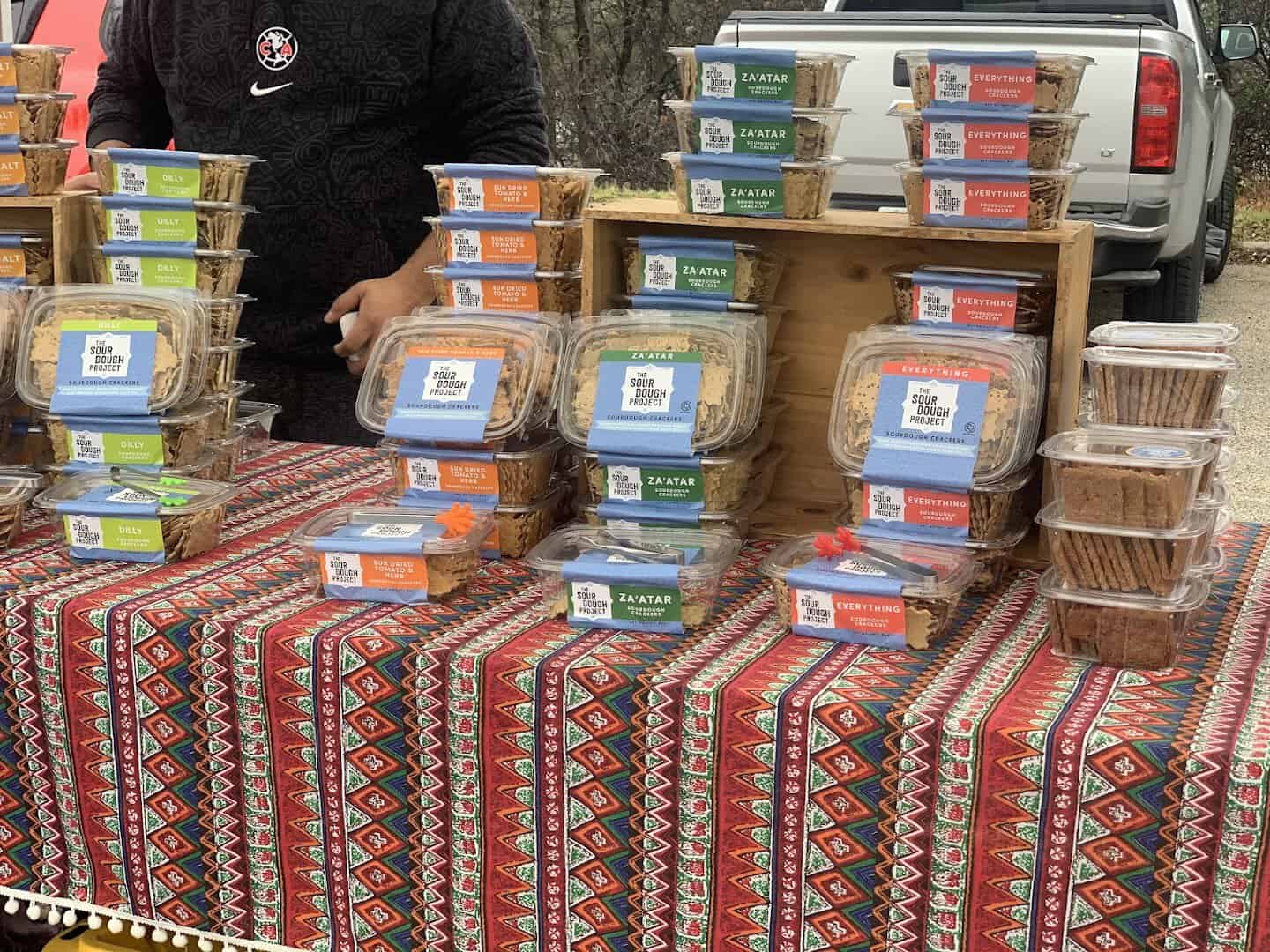 Table of packaged local goods from a vendor at Barton Creek Farmers Market in Austin, Texas