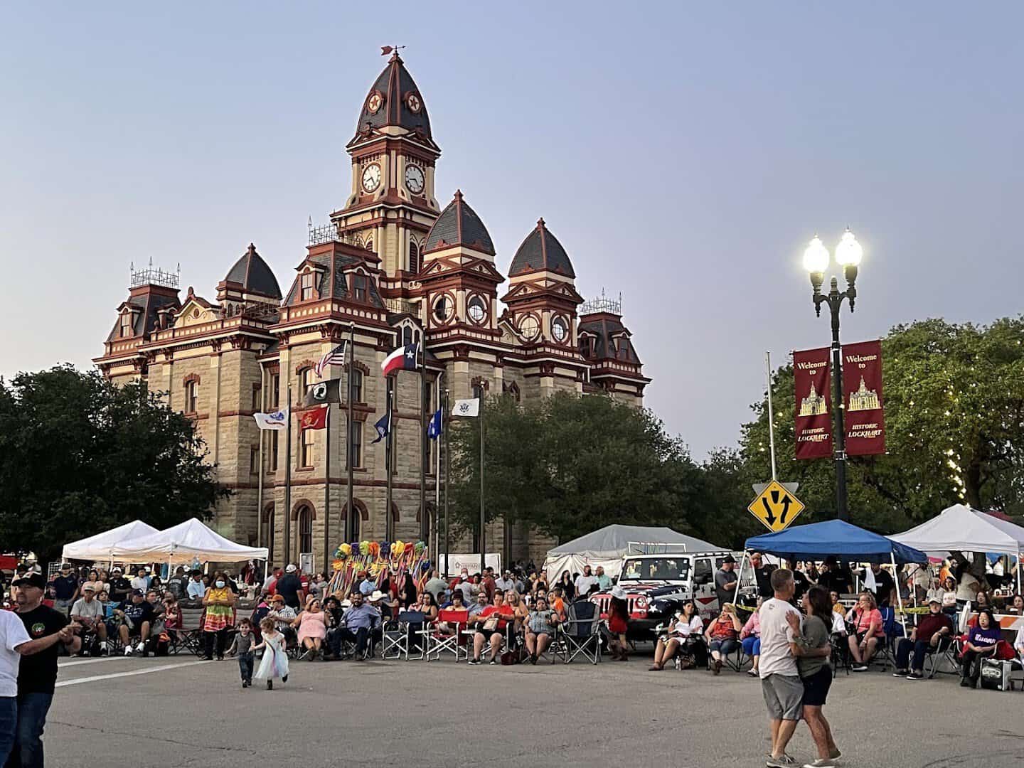 Festival tents and crowd filling the courthouse square in Lockhart, Texas