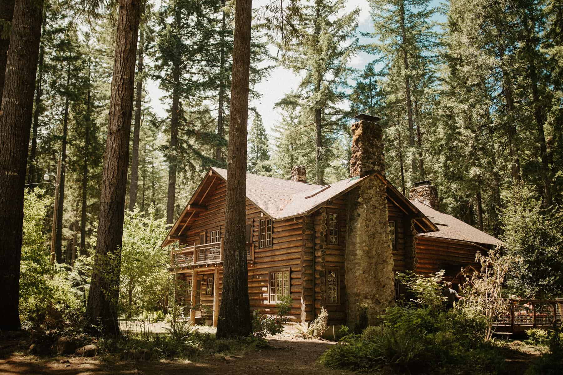 Log cabin among tall firs at Loloma Lodge in McKenzie Bridge, Oregon