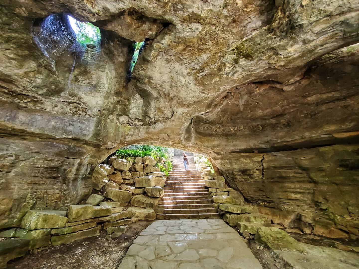 Stone stairway climbing out of the main entrance chamber at Longhorn Cavern State Park in Burnet, Texas