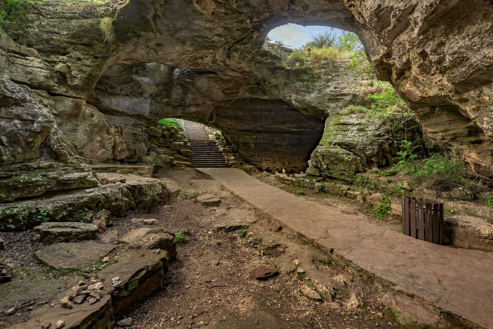 Pale smooth stone arch and passage inside Longhorn Cavern State Park, Texas