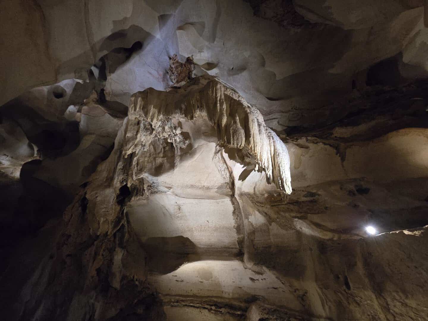 Smooth river-carved chamber and flowstone drapery inside Longhorn Cavern near Burnet, Texas