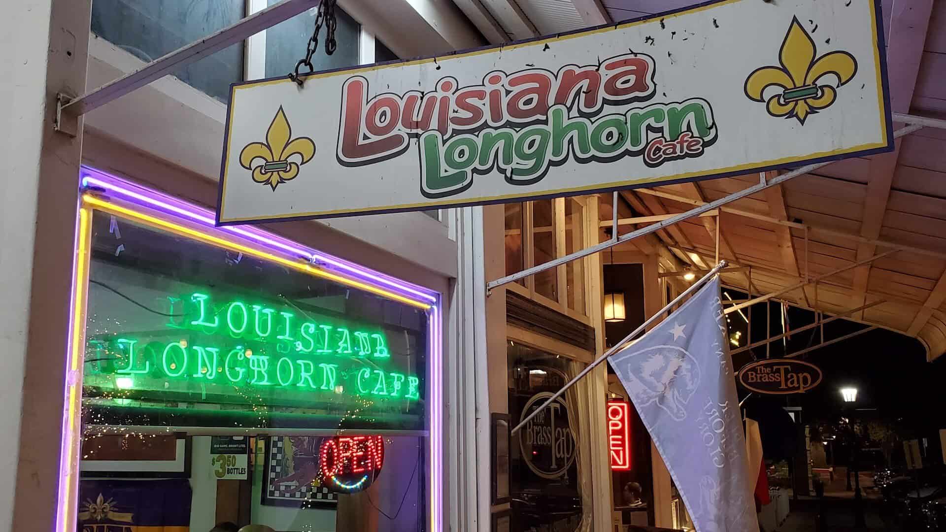 Neon Louisiana Longhorn Cafe sign lit up at night in downtown Round Rock, Texas
